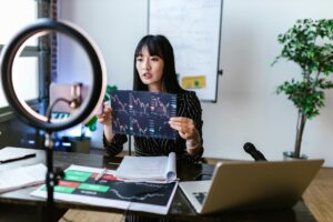 female vlogger holding a sheet of data analysis