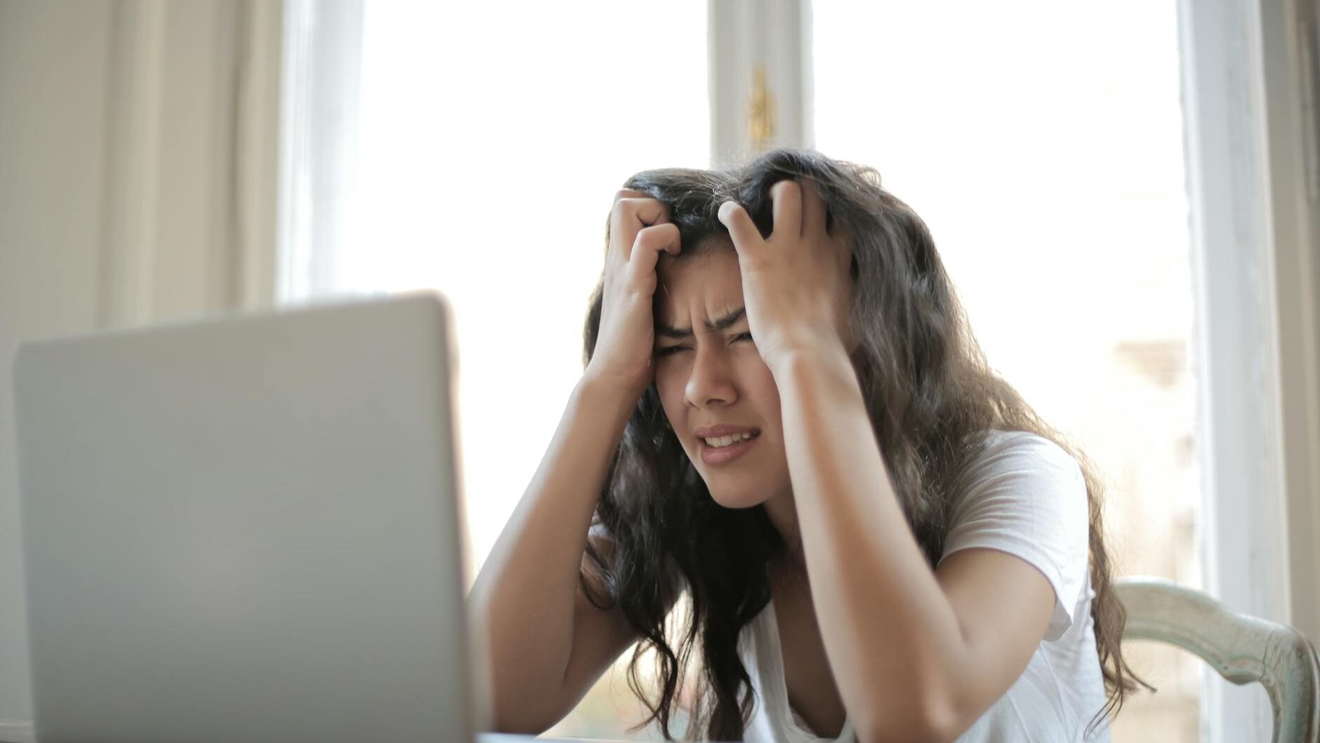 woman in white shirt showing frustration